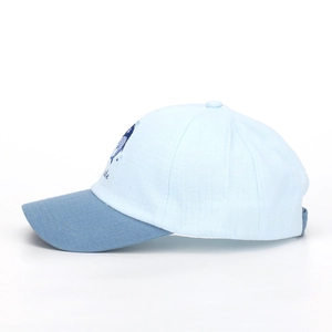Detail of children's baseball cap with blue whale embroidery and contrast visor