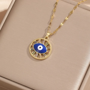 Golden evil eye necklace with colorful zircon pendant on premium jewelry box surface