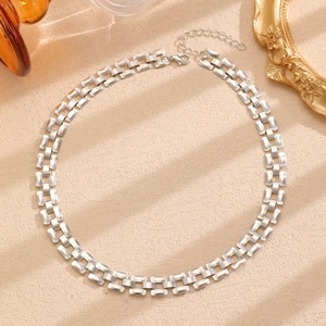 Close-up of silver rectangular link tank chain necklace with lobster clasp and extender