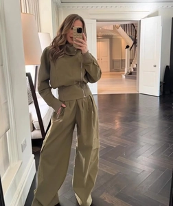 Detail of olive cargo set featuring asymmetric zipper cropped top and wide-leg pants
