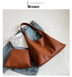 Brown grainy leather Hobo bag with matching zipper pouch and artistic lifestyle props