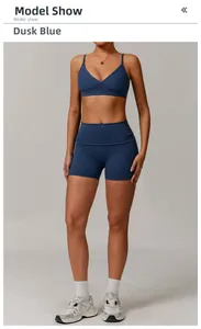 Detail of twilight blue high-waist yoga shorts and V-neck sports bra on model