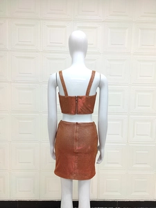 Detail of the back view of the orange sequined crop top and bodycon mini skirt set