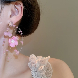 Pink floral tassel earrings with acrylic beads on model for summer beach vacation style