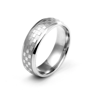 Macro view of 6mm silver titanium steel ring with checkered pattern and polished edges