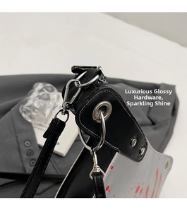 Close-up of premium silver metal rings and spring hooks on a punk style crossbody bag