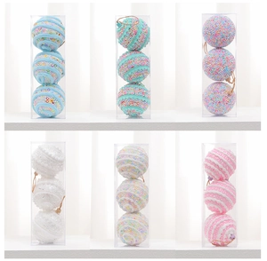 Detailed view of 8cm macaron Christmas balls with sequins and foam in clear boxes