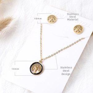 Macro shot of 14mm tree of life pendant and 10mm earrings on white jewelry display card