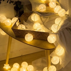 LED cotton ball string lights with warm yellow glow for cozy indoor room decoration