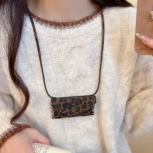Vintage leopard print leather mini bag pendant necklace for women on white knit sweater