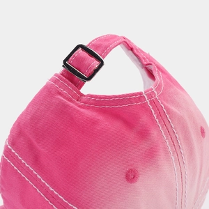 Detail of pink washed cotton baseball cap with adjustable metal buckle and contrast stitching