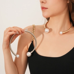 Detail of gold and silver pearl chokers showing metal coil texture and elegant pearl ends