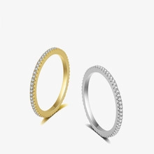 Detailed side view of slim gold and silver stackable rings with inlaid cubic zirconia