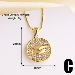 Detail showing gold graduation cap pendant dimensions 21mm by 18mm with zircon stones