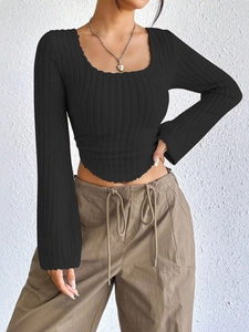 Detail showing the ribbed knit texture and ruffled edges of the black square neck top