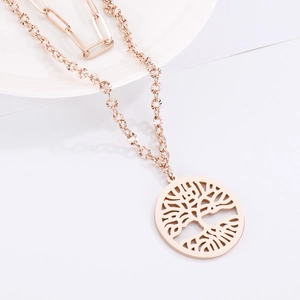 Detail of rose gold double-layer necklace featuring a cutout Tree of Life pendant