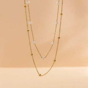 Minimalist double-layer gold chain necklace featuring white beads and metallic spheres