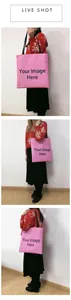 Detailed live shot of a pink customizable canvas tote bag with black shoulder straps