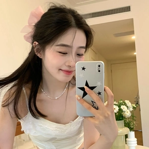 Detailed close-up of a pink mesh bow hair claw and delicate silver necklace for women