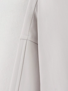 Macro shot of precise stitching and twill fabric texture on the light gray outdoor jacket