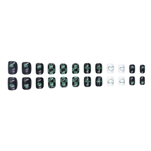 Press-on nail set featuring black and green heart checkerboard patterns on white background