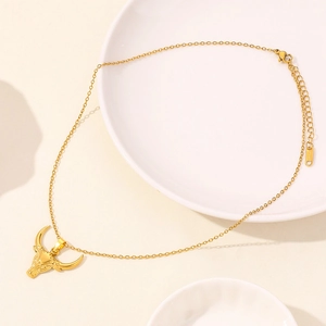 Detail of gold bull head pendant on stainless steel O-chain with secure lobster clasp