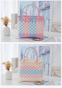 Detail of woven picnic basket bags showing pink and blue plastic weaving texture