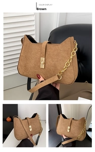 Close-up of brown faux suede shoulder bag featuring a gold metal twist lock and wavy edges