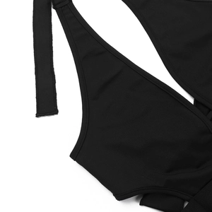 Detail view of precise stitching and elastic knit fabric on black lace jumpsuit