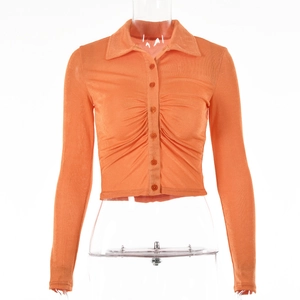 Detail of orange ruched cardigan with lapel collar and single breasted texture buttons