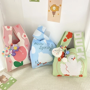 Three cute knitted tote bags in pink cherry, blue cloud, and green duck designs