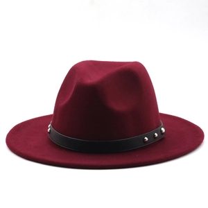 Detail of burgundy wool fedora hat with black leather band and silver metal rivets