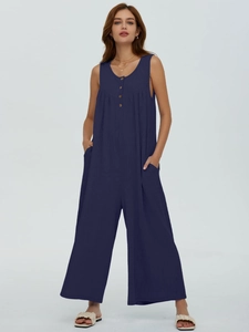 Detail of dark blue ribbed knit jumpsuit featuring sleeveless design and side pockets