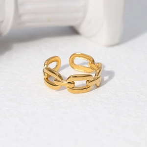 Close-up of golden chain-style open ring on white architectural display props