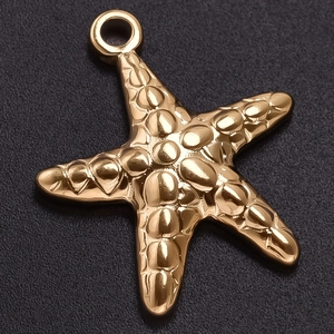 Macro shot of gold starfish pendant with lifelike texture on a dark textured surface