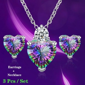 Detailed set of silver cross pendant necklace and heart-shaped crystal earrings