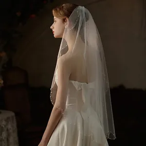 Elegant white bridal veil with pearl beaded edges and metal comb for wedding