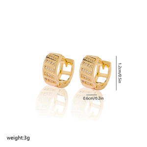 Detailed view of gold plated huggie earrings with four rows of cubic zirconia stones