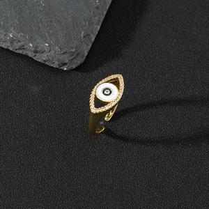 Macro shot of gold evil eye ring with blue enamel and sparkling pavé zircon stones