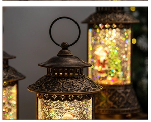 Macro view of vintage bronze Christmas snow globe lantern with glittering LED scene