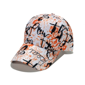 Graffiti print baseball cap with orange floral patterns and black street style lettering