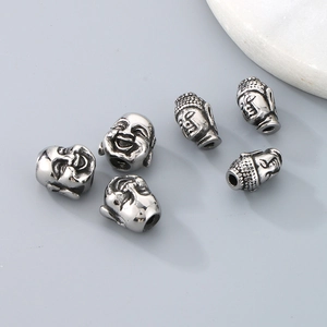 Macro detail of six stainless steel Buddha head spacer beads for DIY jewelry making