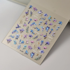 Detail of 3D embossed nail art sticker featuring purple flowers and gold butterflies
