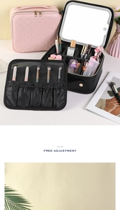 Detail view of pink quilted LED makeup case with adjustable dividers and brush storage