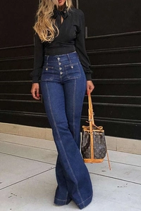 Detailed close-up of high waist dark blue denim flared jeans with multi-button closure