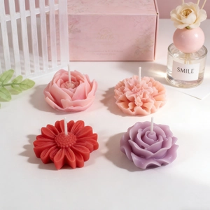 Floral scented candle set with rose and carnation designs in an elegant pink gift box