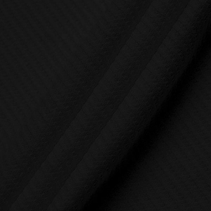 Macro view of black waffle knit fabric texture showing vertical stripe details on polo shirt