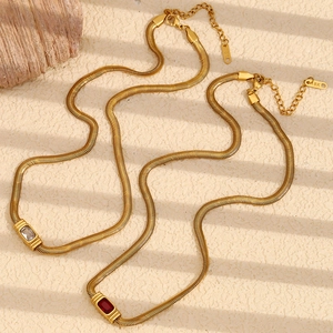 Detail of 18K gold-plated snake chains featuring red and white zircon gemstones