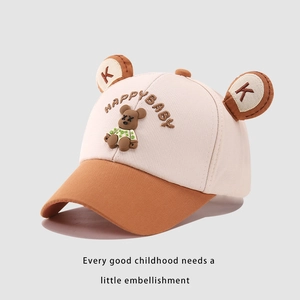 Detail of kids baseball cap with bear ears and Happy Baby embroidery in cream and brown