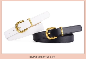 Close-up of elegant bamboo-style gold metal buckles on white and black PU leather belts